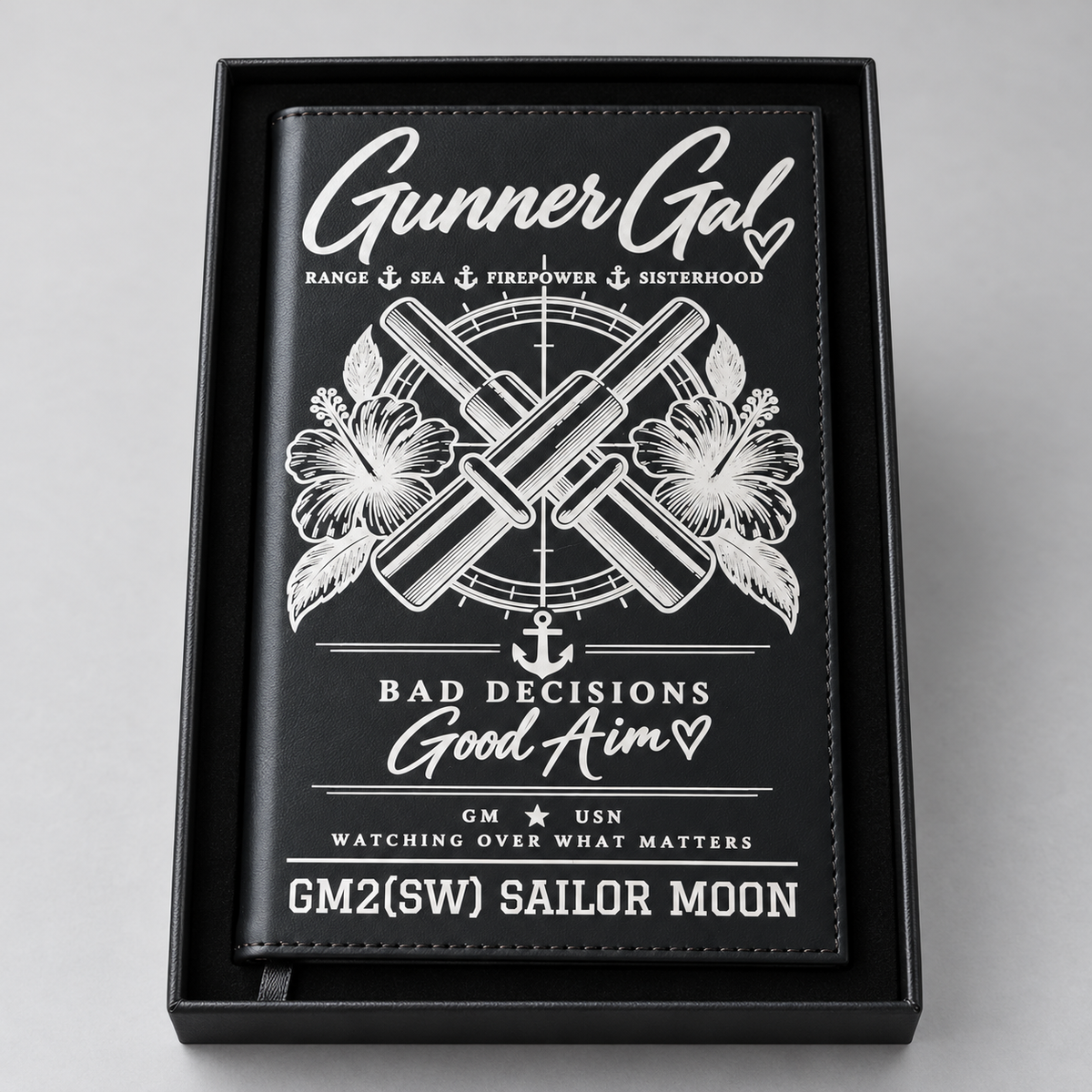 Black GunnerGal refillable notebook with crossed cannons, flowers, and personalized text, shown in a black gift box