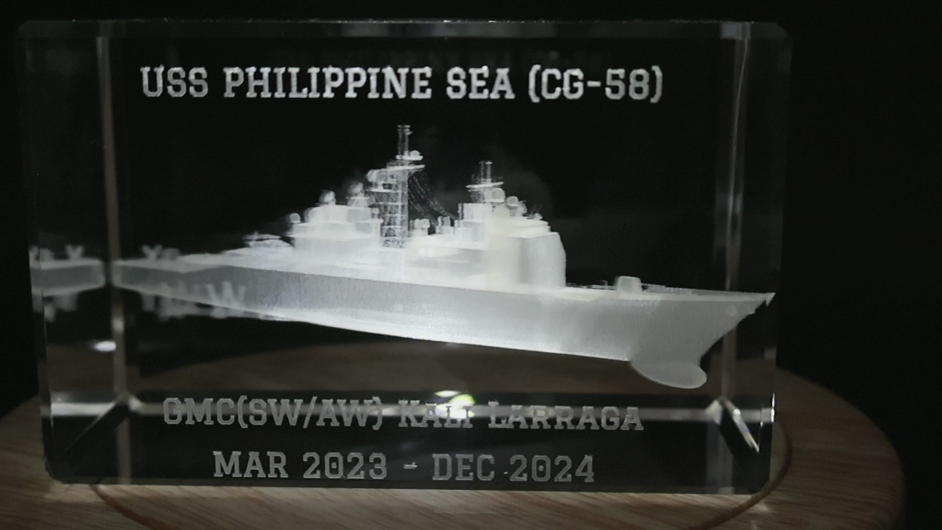 Close-up of personalized ship name, recipient name and dates on a cruiser crystal